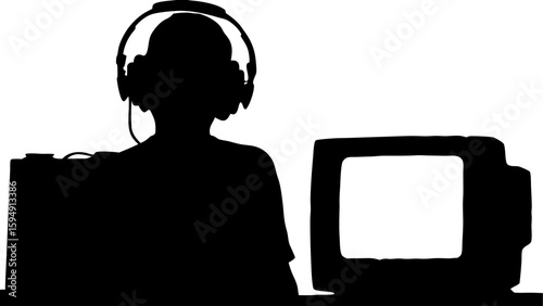 Silhouette of person wearing headphones sitting in front of a computer and a large device on a desk