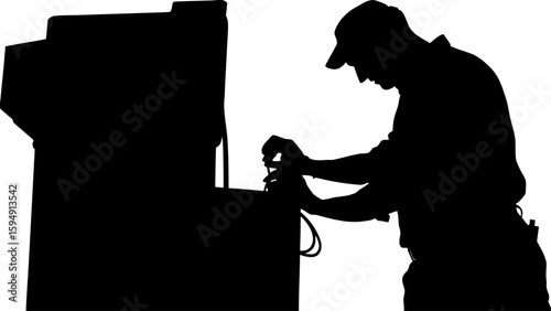 Silhouette of a man in a cap working on a machine with his hands near the top of the equipment