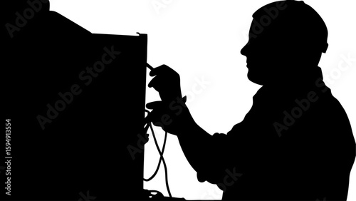 Silhouette of a technician working on computer cables with a focused expression and careful hand movements