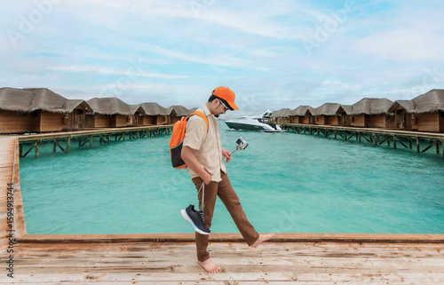 A male tourist with a backpack vlogging himself while exploring a charming overwater resort
