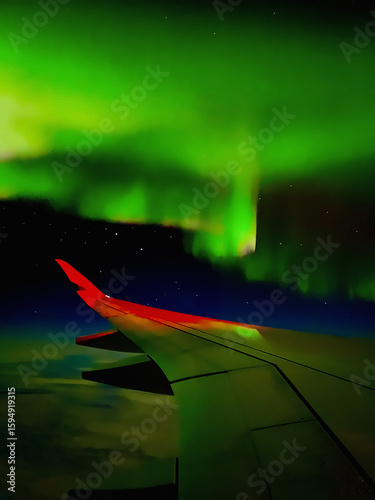 Breathtaking view of the Northern Lights (Aurora Borealis) seen from airplane window over Fairbanks, Alaska- Stunning aerial night sky phenomenon, glowing green waves above clouds.