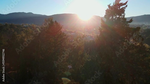drone traveling in mountain and forest backlit