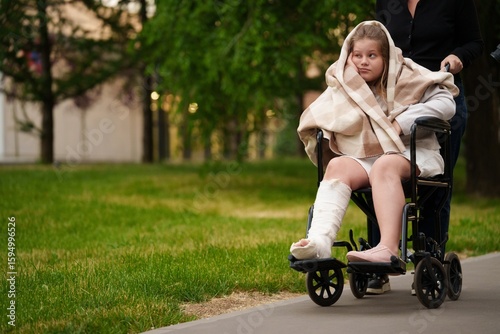 Φωτογραφία Girl with broken leg sits in wheelchair, sadness in her eyes as active childhood fades, sadness wrapped in blanket and silence, sadness shaped by injury and longing to run