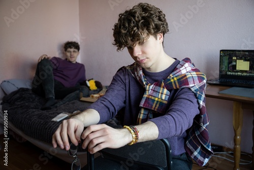 Young adults engage in creative leisure at home during a cozy afternoon in a warm and inviting shared space