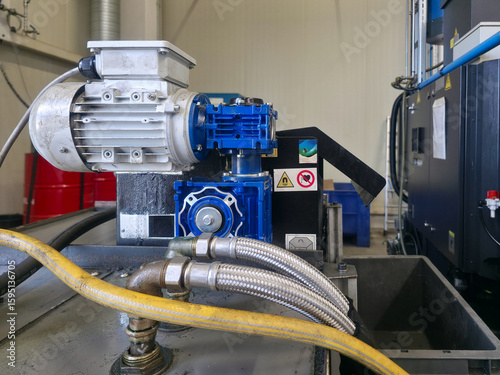 Industrial machinery at a manufacturing facility shows a hydraulic power unit during operational time in a workshop