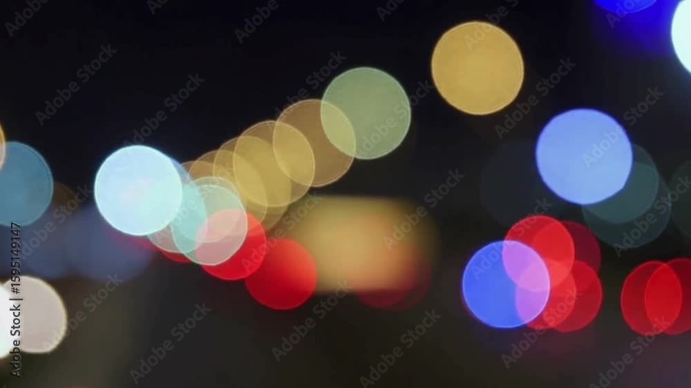 Loopable footage of colorful bokeh city lights slowly shifting out of focus, soft camera movement, cinematic night ambience