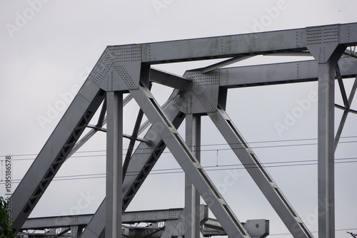Fotografie A gusset plate, a section of a steel bridge structure against the clear sky back