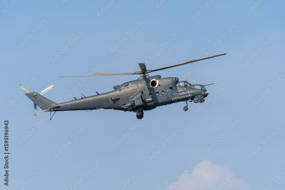 Obraz premium Soviet-made black old military helicopter flying in the sky in Budapest