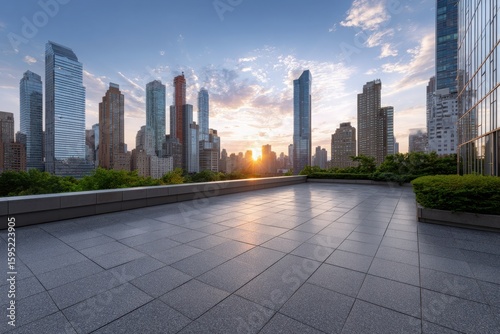 Modern city skyline at sunset with reflection on wet pavement and lush green trees
