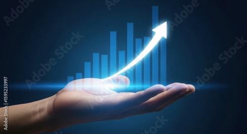 Hand holding glowing upward arrow and financial growth chart