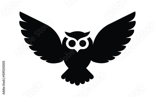Black silhouette of an owl with wings spread wide in flight