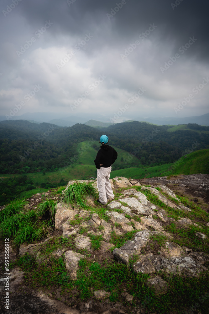 custom made wallpaper toronto digitalConfident woman standing on a rocky cliff during a trek in Windy Walk Forest, Vagamon, Idukki, Kerala.