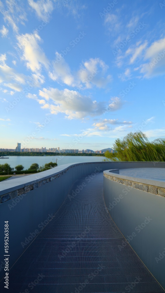 Fototapeta premium Modern Pathway Overlooking Serene Lakeside Cityscape