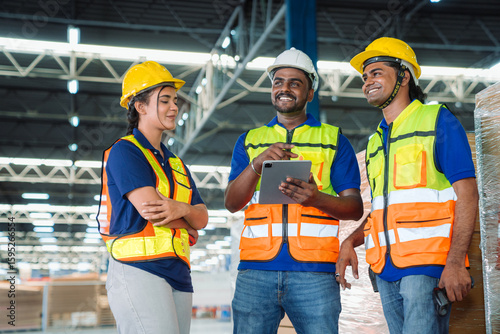 Diverse workfoce team black men,woman factory worker wear safety helmet, safety vest use tablet for industrial warehouse job.Teamwork efficient success modern logistic manufacture operation management
