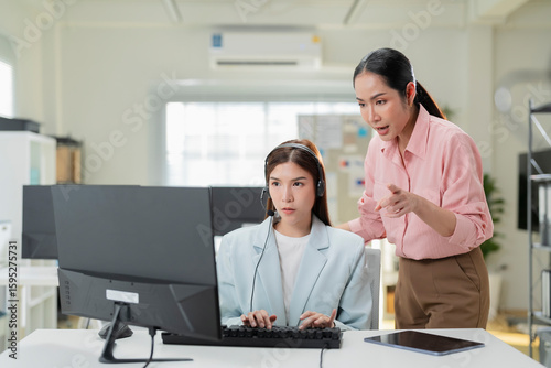 Tableau sur toile Cheerful mature coworkers and confident operators cooperating on customer cases