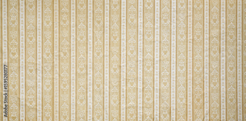 Old wallpaper on the wall. Old wallpaper for texture or background.