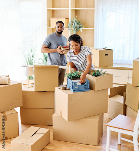 Portrait of a young couple unpacking, moving in and relocation to a new apartment, happy young couple family new beginning