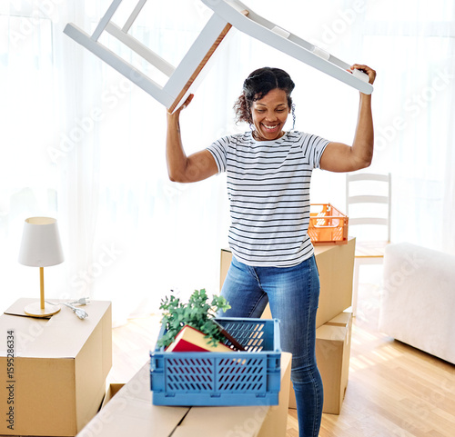 Young black couple moving into a new modern house, carrying boxes, plant and chair and arriving home together. Happy, excited and smiling husband and wife walking, entering and relocating after buying