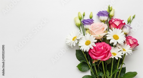 Mixed flower bouquet with roses and daisies, top view with copy space.
