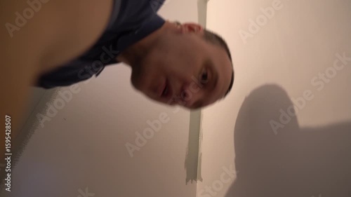 The process of painting walls in which the surface is painted with paint using a brush. For uniform application of paint. Apartment renovation. High quality 4k footage