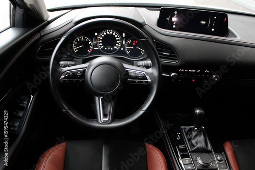 Canvas Print View of the steering wheel and dashboard of the car from the driver's point of view