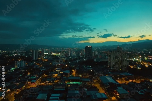 Aerial hyperlapse of San Jose Costa Rica showcases city lights and evening sky, San Jose, Costa Rica aerial hyperlapse Drone timelapse moving over city dusk to night