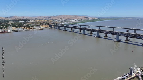 Wallpaper Mural hovering above Carquinez Strait near Martinez, right panning along Benicia-Martinez Railroad Bridge and Benicia–Martinez Bridge, with traffic running on Highway - 4k aerial video footage Torontodigital.ca