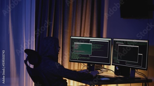 Night-time scene of a developer programming in low light. Сyber defense, hacking prevention, modern digital environments. Modern outsourcing workspace.