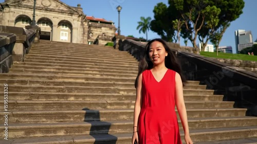 Young woman in red dress on outdoor stairs