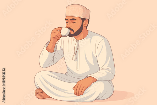 Man wearing traditional Omani clothing sits cross-legged while drinking from a small white cup.