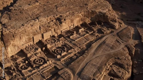 An aweinspiring aerial view captures the ancient persian necropolis of naqshe rustam, with its monumental rockcut tombs carved into a towering cliff face