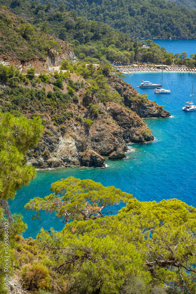 Naklejka premium Boncuk Bay, Blue Lagoon and Oludeniz beach aerial panoramic view. Oludeniz is a beach resort in the Fethiye district of Mugla Province, Turkey.