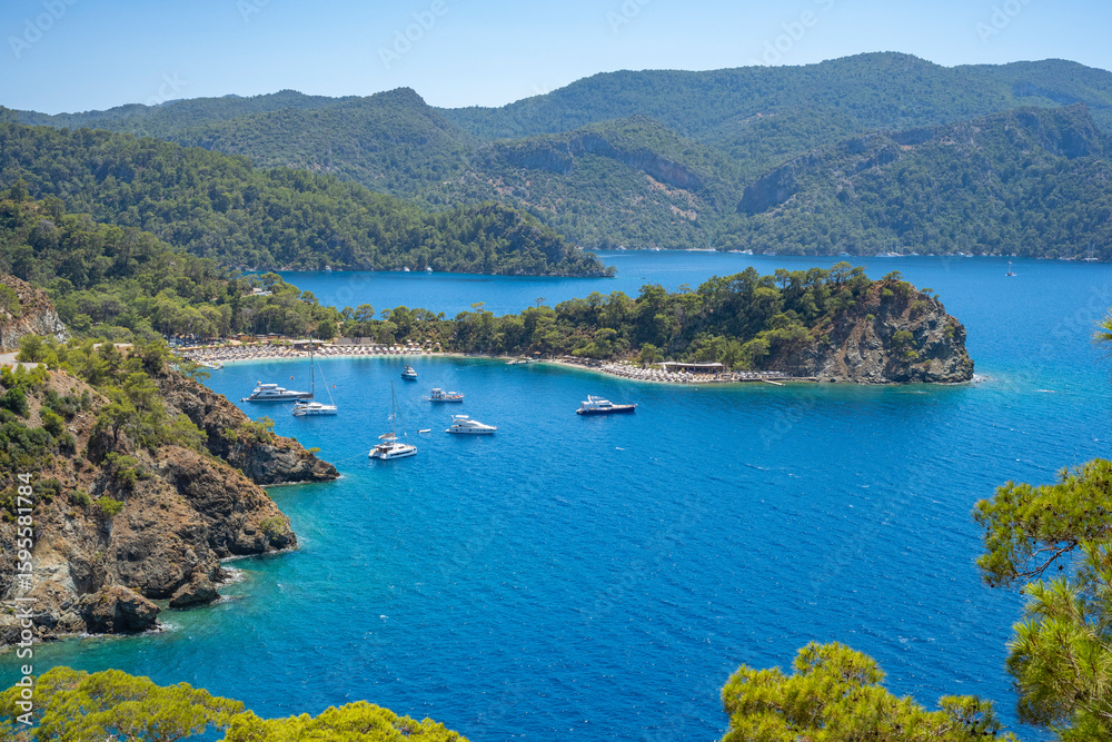 Fototapeta premium Boncuk Bay, Blue Lagoon and Oludeniz beach aerial panoramic view. Oludeniz is a beach resort in the Fethiye district of Mugla Province, Turkey.