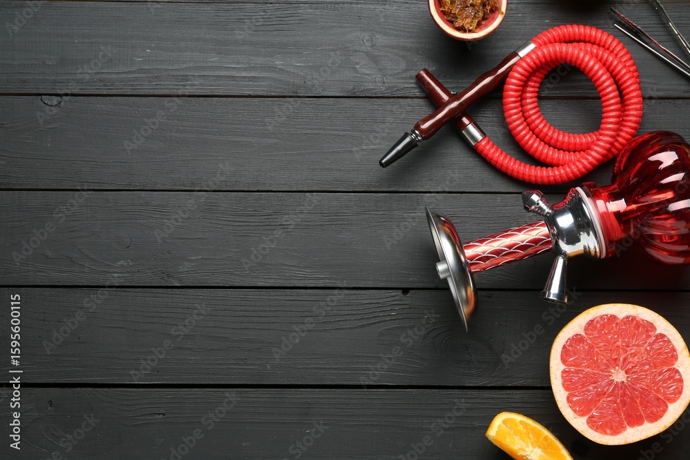 Hookah and fresh fruits on black wooden table, flat lay. Space for text Hookah and fresh fruits on black wooden table, flat lay. Space for text