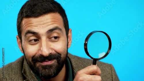 Curious Man Investigating with Magnifying Glass Against Blue Background