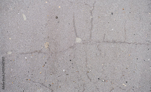 Textura de pavimento de concreto con grietas y partículas visibles