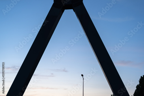  Urban skyline at dusk framed by a bridge structure.