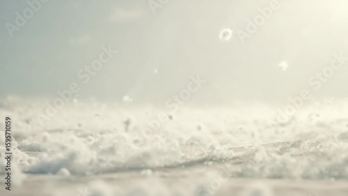 White, fluffy, dispersed objects on a light-colored surface.