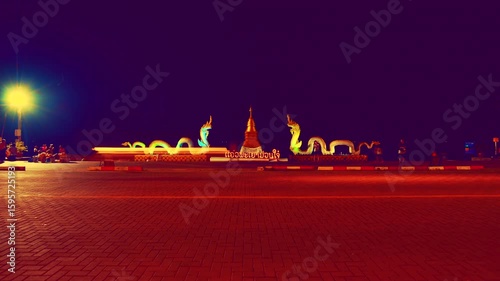 Phayao Series - Timelapse shot of two white Naga statues in the lake and The atmosphere beside Kwan Phayao at night. The most famous landmark in Phayao Province, Thailand.