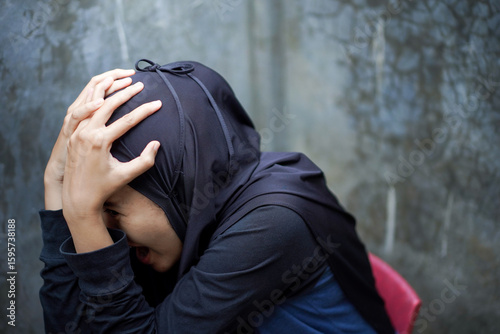 Frustrated sad woman, crop body view young caucasian muslim girl in hijab sitting floor frustrated sad woman. Thinking, nervous, stress, depression concept idea.
