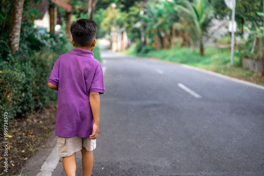 Child walking alone in a city park on a very sunny day. High quality photo Child walking alone in a city park on a very sunny day. High quality photo