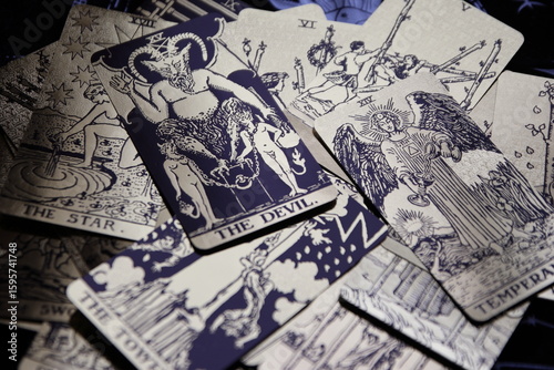 Mystical atmosphere captured through a detailed tarot card arrangement on a textured surface. Rich symbolism and traditional esoteric themes evoke intuition, divination, and spiritual insight. Ideal f