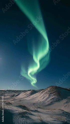 Wallpaper Mural Stunning aurora borealis display over a snow covered landscape under a moonlit night sky. Emerald green lights dance and swirl across the dark blue canvas. Torontodigital.ca