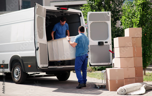 Moving Crew Unloading Furniture From Truck