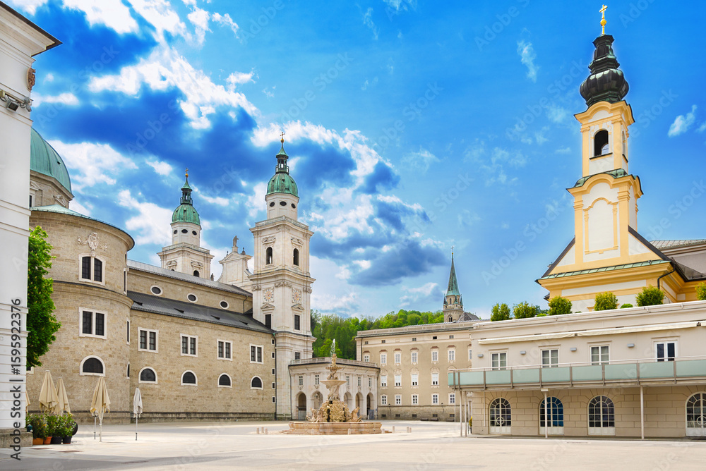 Obraz premium Salzburg Residenzplatz with Cathedral, Old Residence, and St. Michaels Church. Large square in the historic center of Salzburg in Austria, and with the Baroque fountain Residenzbrunnen in the center.