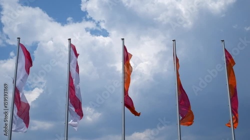 flags waving in the wind against cloudy sky