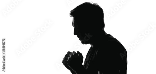 Silhouette of a man with clenched fists expressing triumph or determination