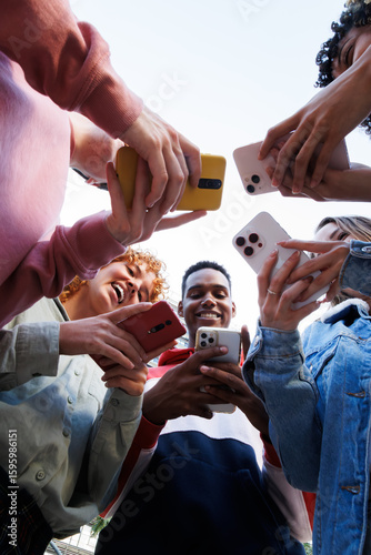 Group of students using smartphones, sharing content, and connecting on social media