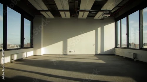 Bright Spacious Room with Large Windows and Sunlight, Ideal for Modern Office Space or New Beginning, Offering Potential and Opportunity.