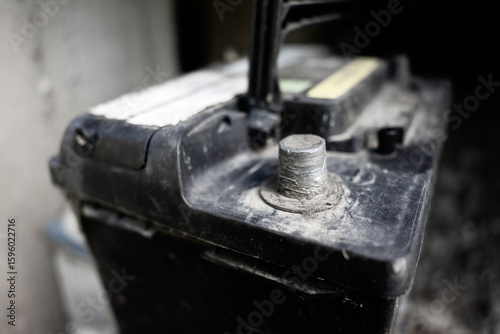 Used, worned car battery close up shot, focus on the battery terminal.
